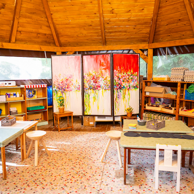 Children painting in forest playhouse Simplicity Retreat