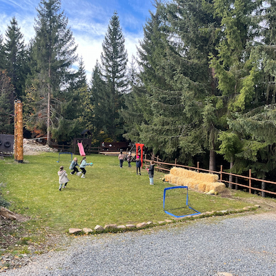 Children playing at outdoor playground Simplicity Retreat